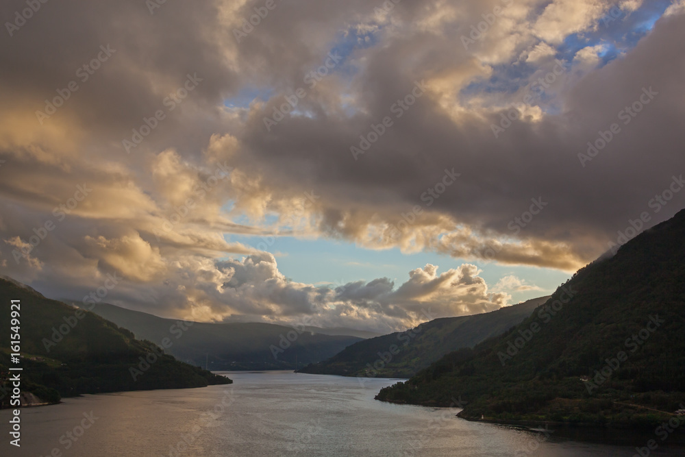 Dramatic sunset in clouds on the Norwegian fjord