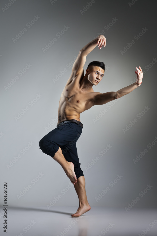 Young and stylish modern ballet dancer on grey background Young and stylish modern ballet dancer on grey background