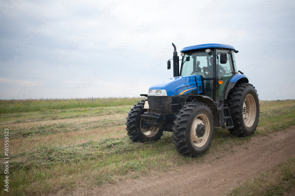 pasture mowing with blue tractor and mower pasture mowing with blue tractor and mower