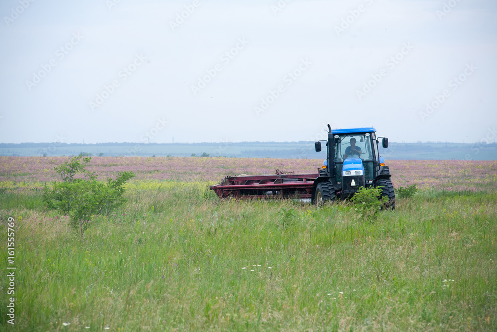 pasture mowing with blue tractor and mower pasture mowing with blue tractor and mower