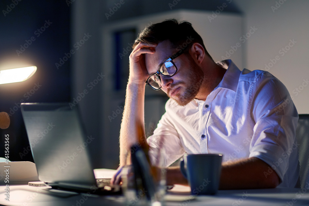 businessman with laptop thinking at night office businessman with laptop thinking at night office
