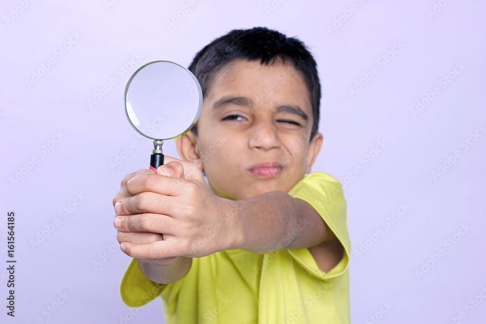 little indian boy holding magnifying glass little indian boy holding magnifying glass