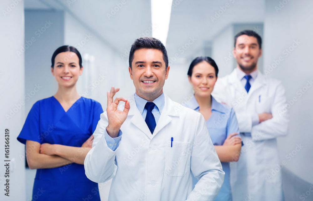 group of medics at hospital showing ok hand sign group of medics at hospital showing ok hand sign