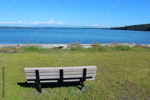 An empty bench with a beautiful bay view waiting for someone to sit and relax  © octobersun