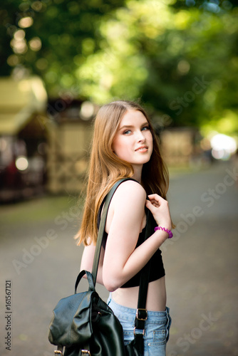 Young beautiful stylishly dressed girl is walking along the streets of the city, talking on mobile phone © Анна Ковальчук