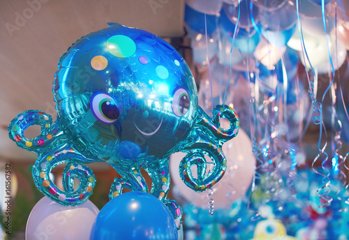 Festive decorated selling with blue tone helium balloons, birthday party