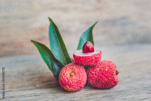 Fresh litchi fruit on an old wooden background photo