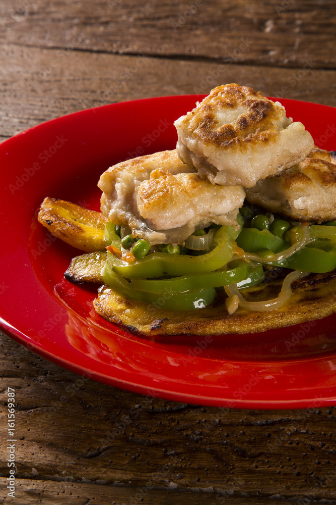 Tucunare fish in butter with green peppers and banana - Traditional Amazonian dish Tucunare fish in butter with green peppers and banana - Traditional Amazonian dish