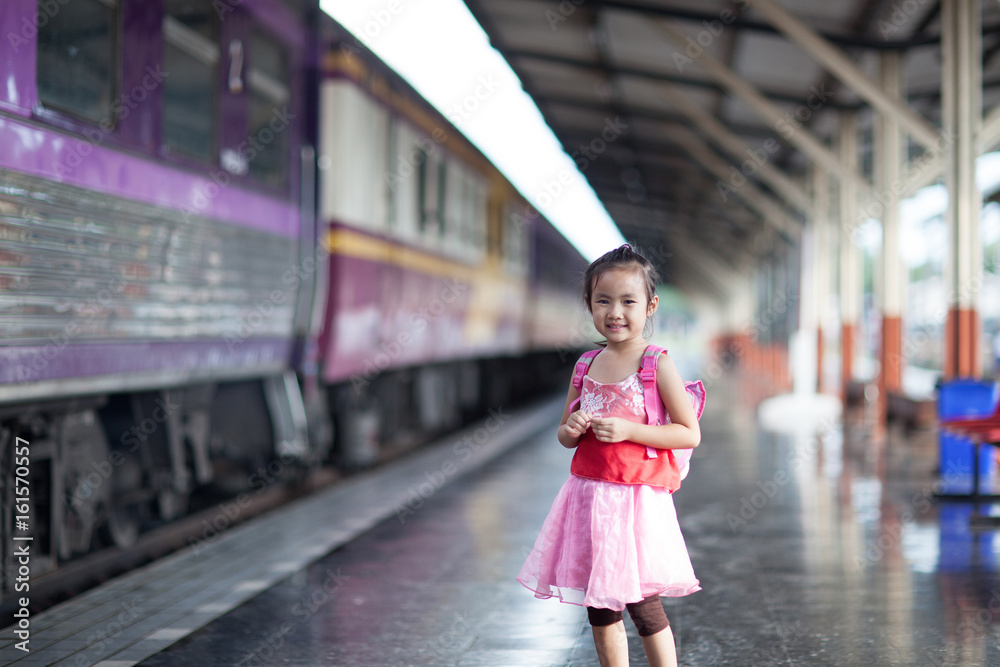 Child Journey by train on platform of railway station in thailand Child Journey by train on platform of railway station in thailand