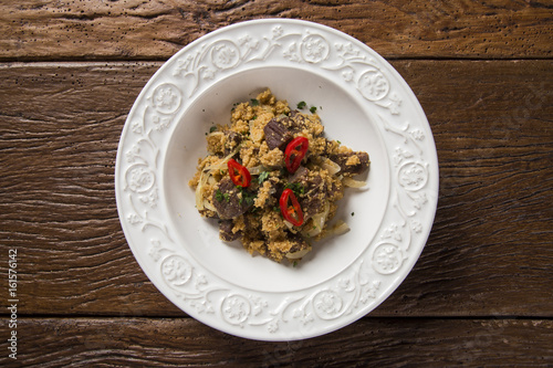 Farofa with dried meat and pepper photo