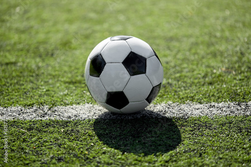 soccer ball on football field marking line © Syda Productions