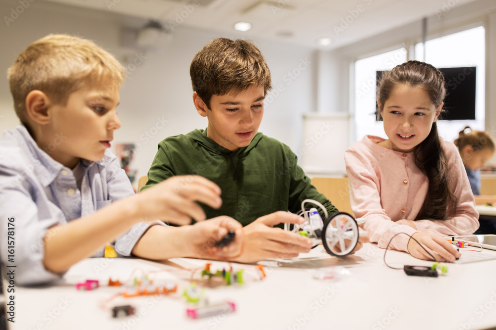 happy children building robots at robotics school happy children building robots at robotics school