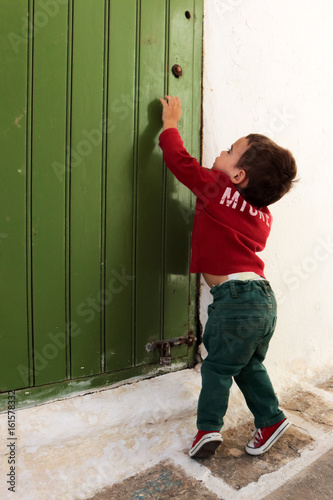 Kid trying to open a door