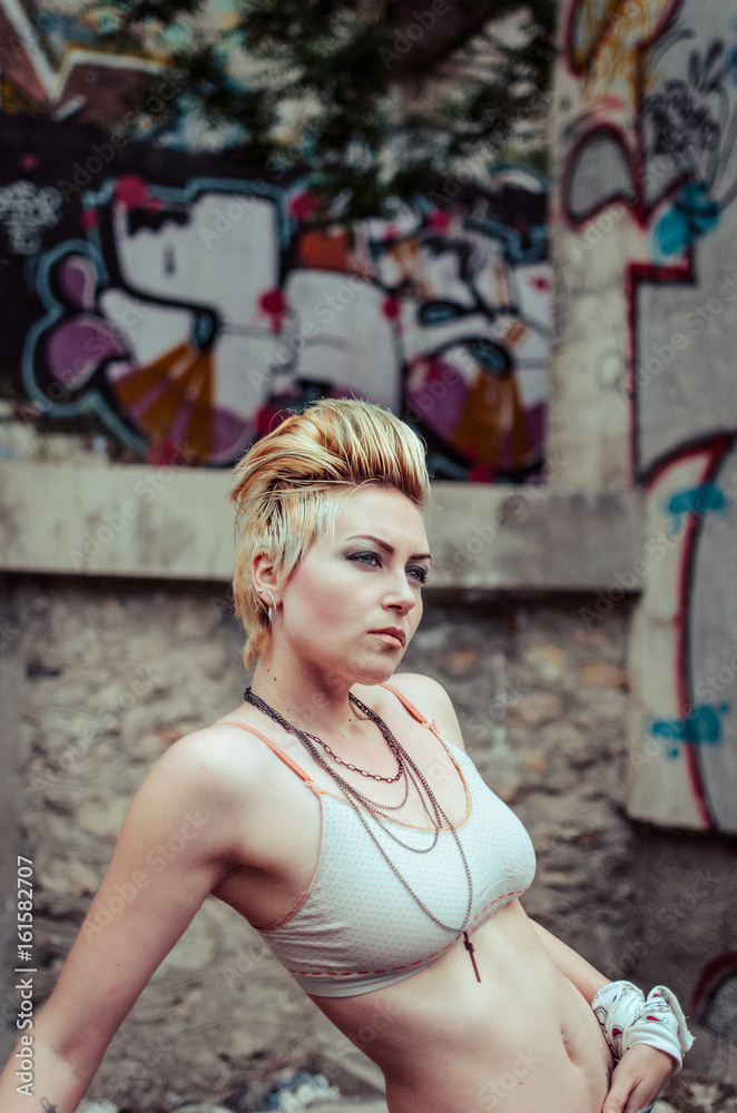 Naklejka premium Hot blonde with colored wall background
