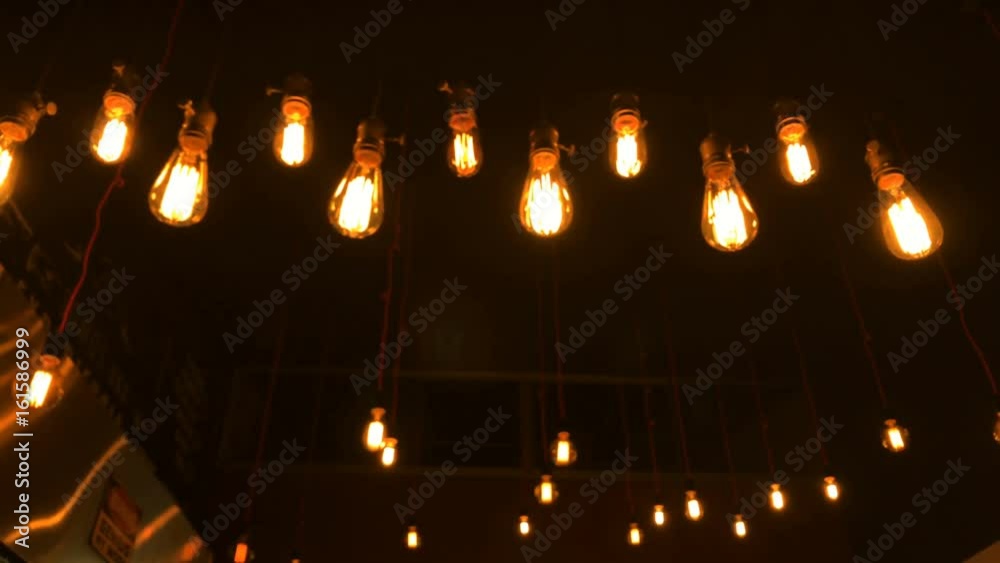 Light bulbs turned on. Vintage tungsten bulbs hanging from the ceiling
