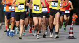 runners during the marathon with the bib number written with 1
