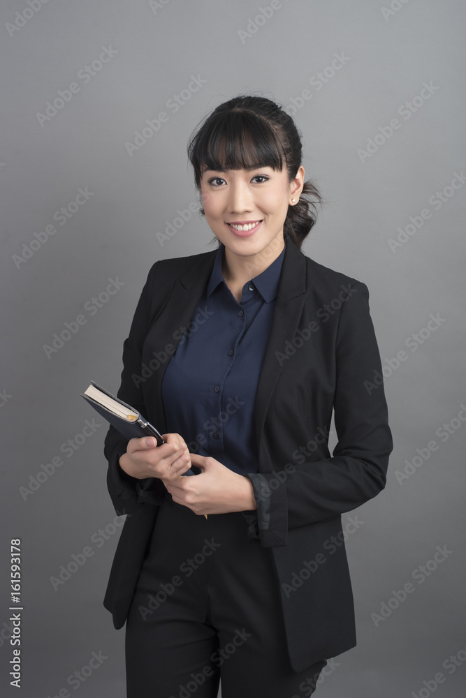 Beautiful Business Woman confident on grey background Beautiful Business Woman confident on grey background