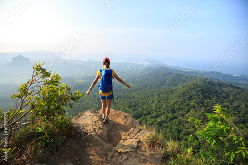 Canvas Print successful woman hiker hiking on mountain peak