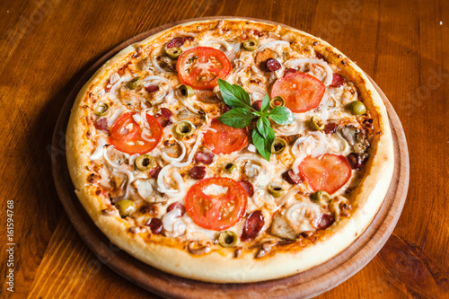 Delicious pizza with meat, cheese and mushrooms