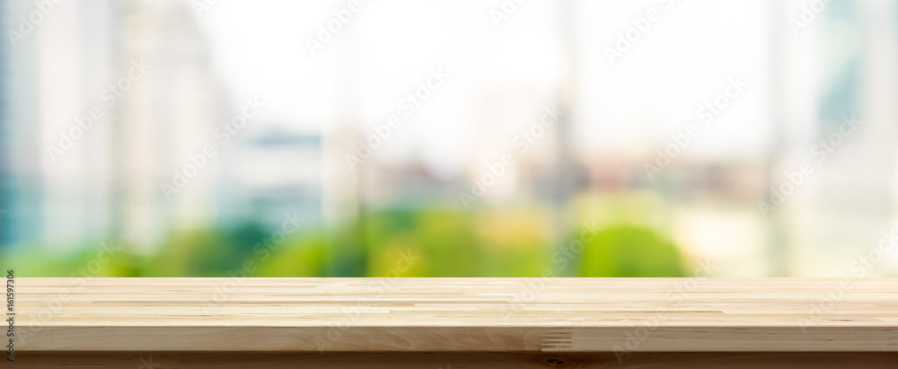 Wood table top on blur  city building view background looking through glass window, panoramic banner - obrazy, fototapety, plakaty 