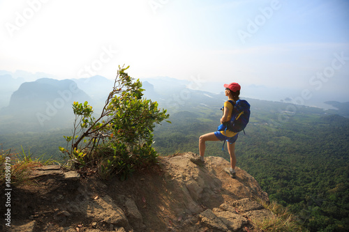 Photography successful woman hiker enjoy the view on mountain peak