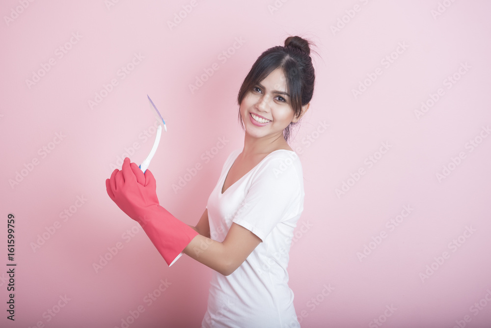 Beautiful asian housewife smiling on pink background Beautiful asian housewife smiling on pink background