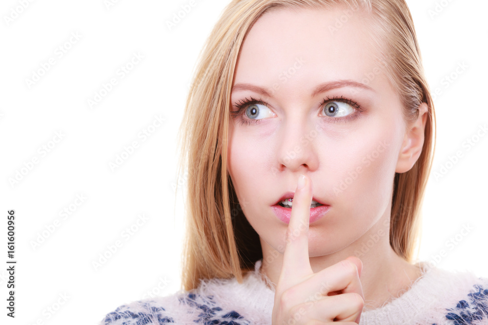 Young blonde woman making silence gesture Young blonde woman making silence gesture