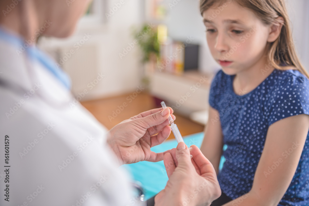 Doctor preparing a vaccine to inject into a patient Doctor preparing a vaccine to inject into a patient