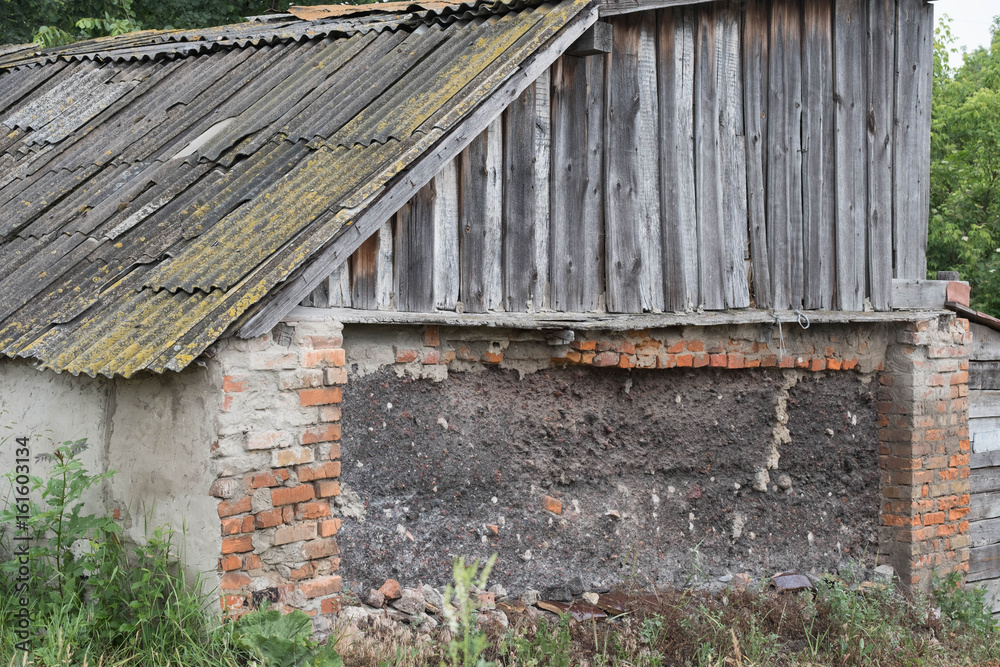 Old building for inventory on a farm with old wooden doors Old building for inventory on a farm with old wooden doors