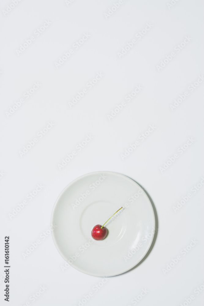 Minimal cherry background. Fruit on white plate. Vertical design for a leaflet, banner, cover or flyer Minimal cherry background. Fruit on white plate. Vertical design for a leaflet, banner, cover or flyer