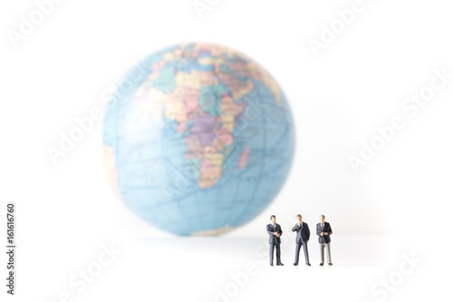 miniature model of businessman standing together and the world background, investor concept, isolated on white background.
