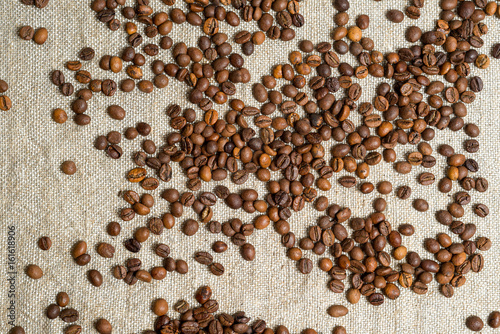 Spilled grains of fragrant coffee close-up.