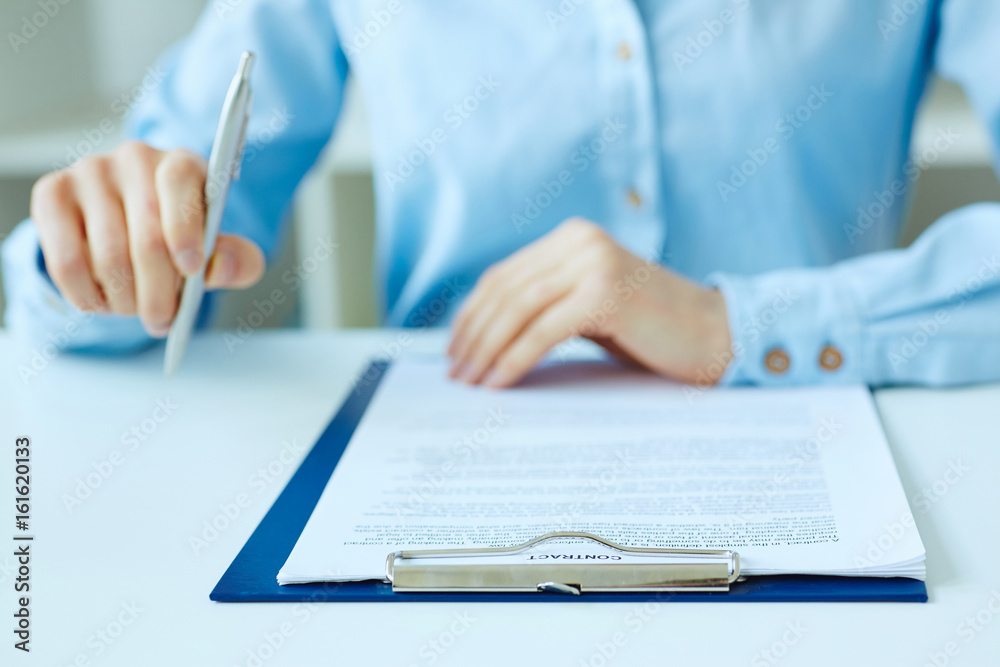 Hands of business woman signing the contract document with pen on desk. selective focus image on sign a contract. Hands of business woman signing the contract document with pen on desk. selective focus image on sign a contract.