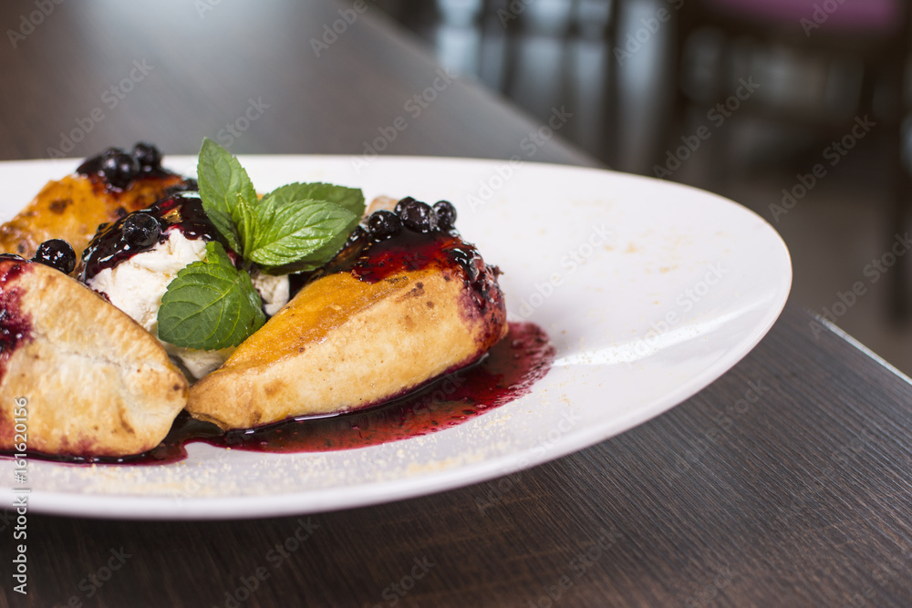 Beautiful dessert in a restaurant. Rolls with strawberry jam. Fresh croissants with ice cream and jam. Beautiful dessert in a restaurant. Rolls with strawberry jam. Fresh croissants with ice cream and jam.