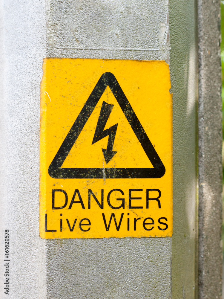 Fototapeta premium yellow electrical lamp post warning sign
