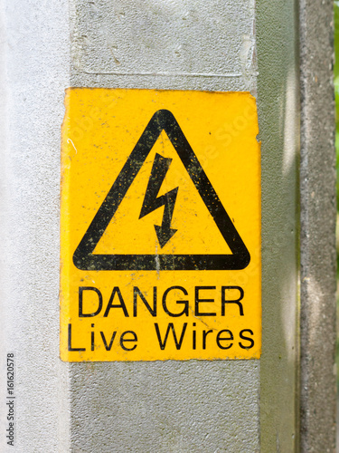 yellow electrical lamp post warning sign