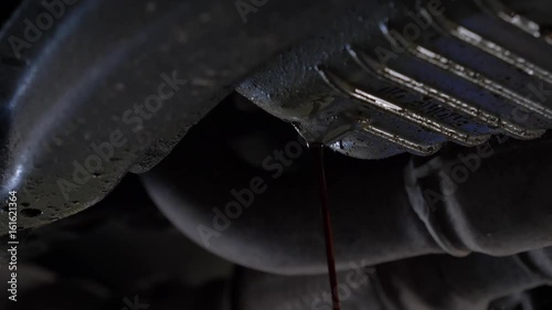 Oil dripping out of a car during an oil change