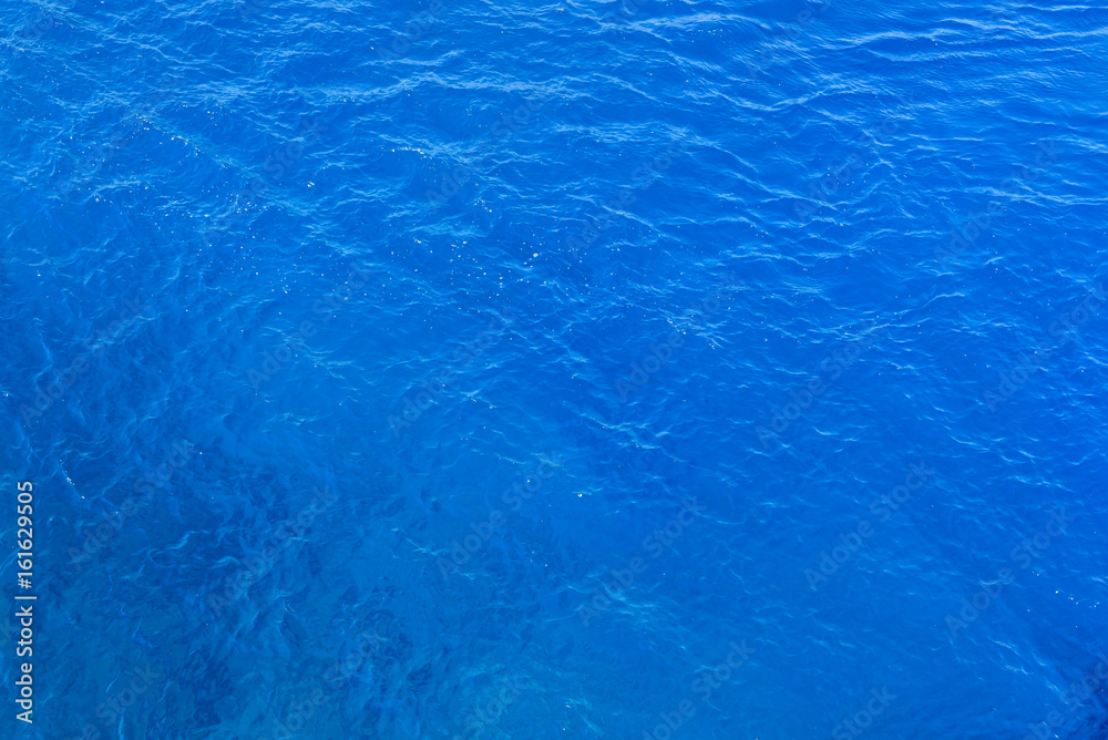 Natural background of blue sea water.