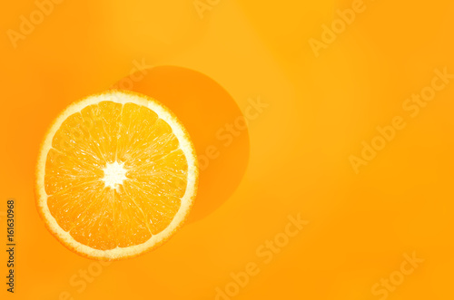 One orange on orange background. Art food concept