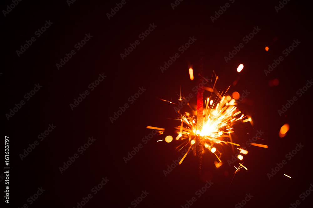 Christmas background with sparkler and copy-space Christmas background with sparkler and copy-space