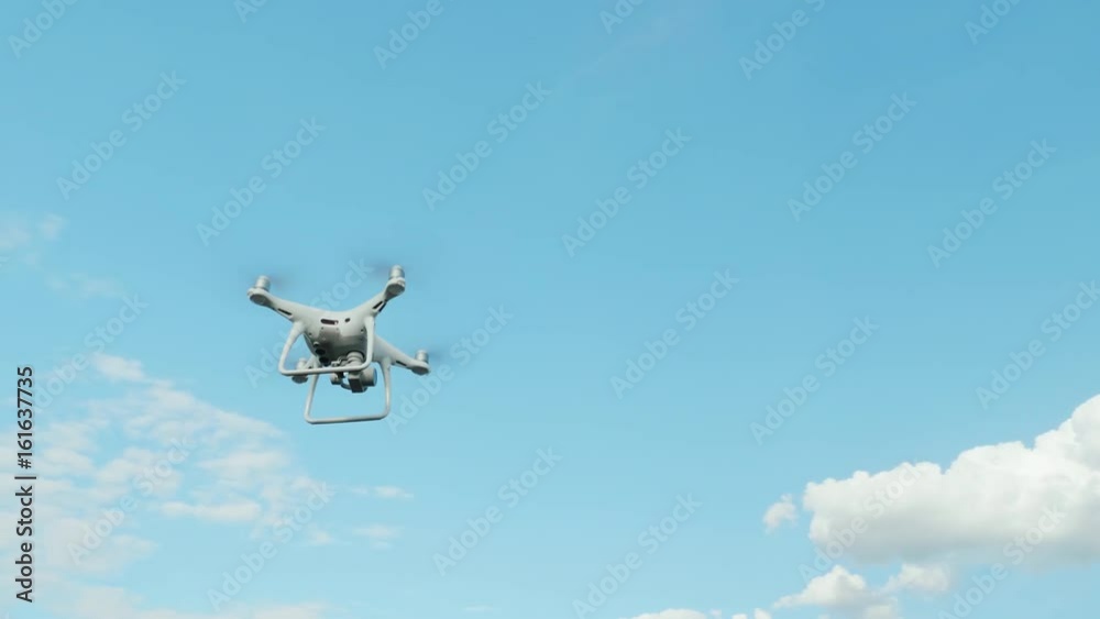 Copter against the blue sky with white clouds Copter against the blue sky with white clouds
