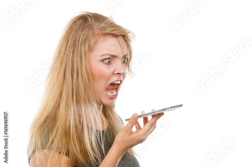 Bild auf Leinwand Angry young woman talking on phone