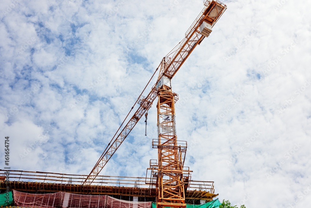 Working crane and building under construction