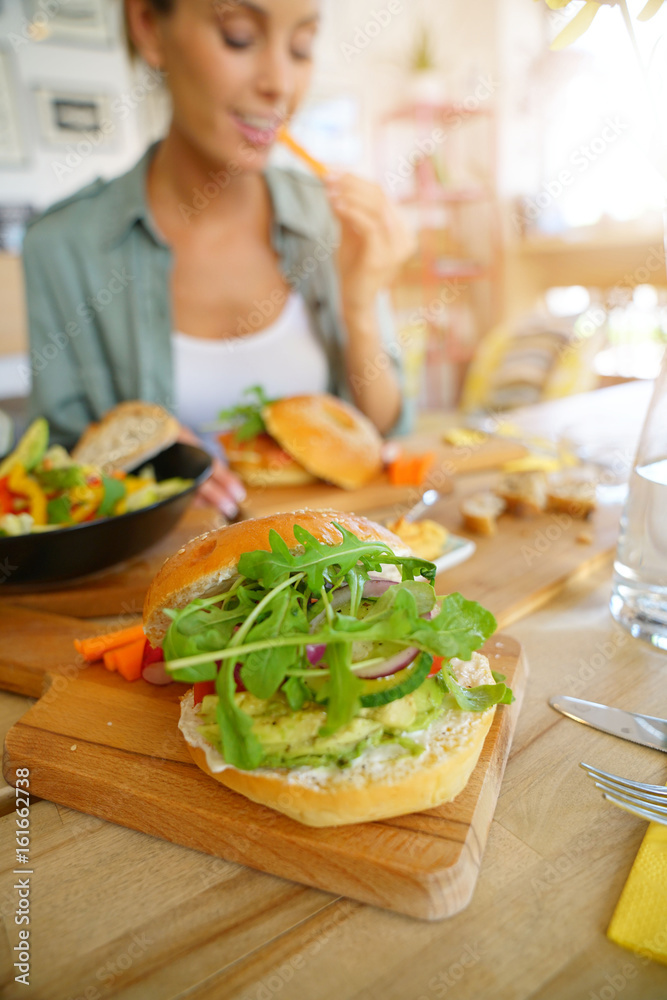Closeup of veggie bagel set on restaurant table