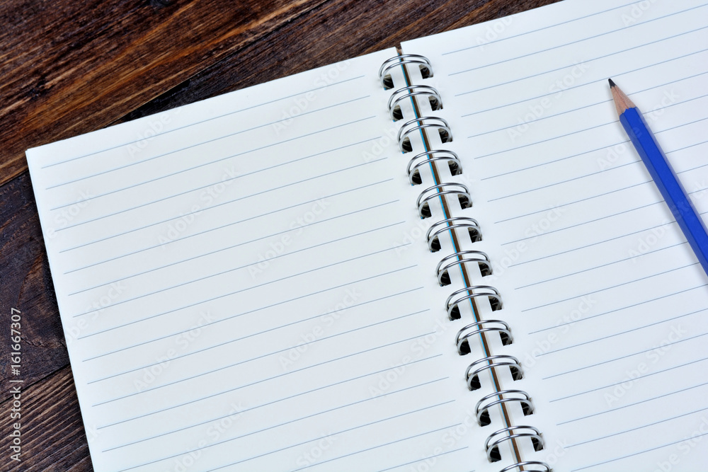Empty notebook with pencil on table Empty notebook with pencil on table