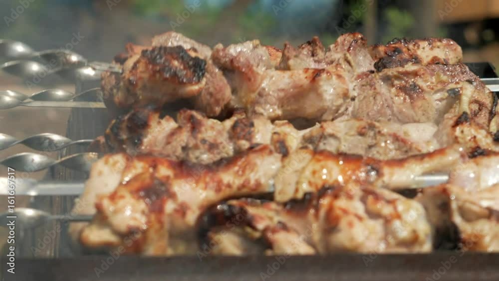 Preparation of meat on charcoal in the street. Chicken and pork are strung on metal pins. Moving camera Preparation of meat on charcoal in the street. Chicken and pork are strung on metal pins. Moving camera