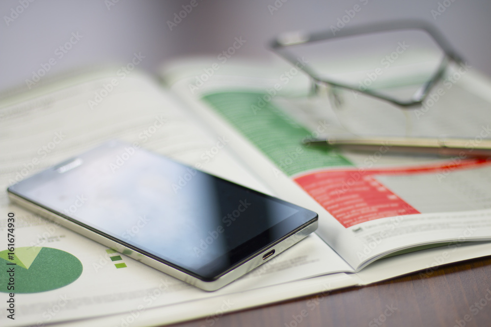 Business chart stiill life with mobile phone, pencil and glasses. Business chart stiill life with mobile phone, pencil and glasses.