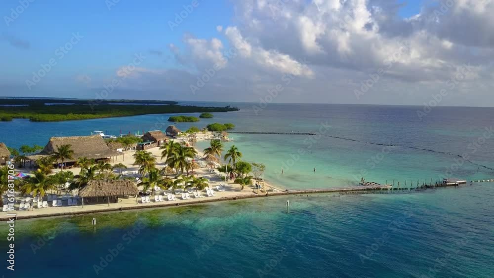 Side view drone shot of island that allows to see amazing crystal blue waters, boats, reefs, and beach life. Side view drone shot of island that allows to see amazing crystal blue waters, boats, reefs, and beach life.
