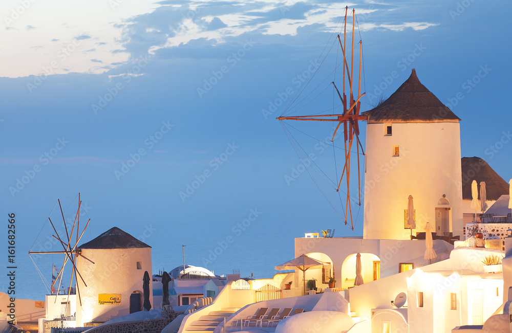Windmills in Santorini at sunset Greece 