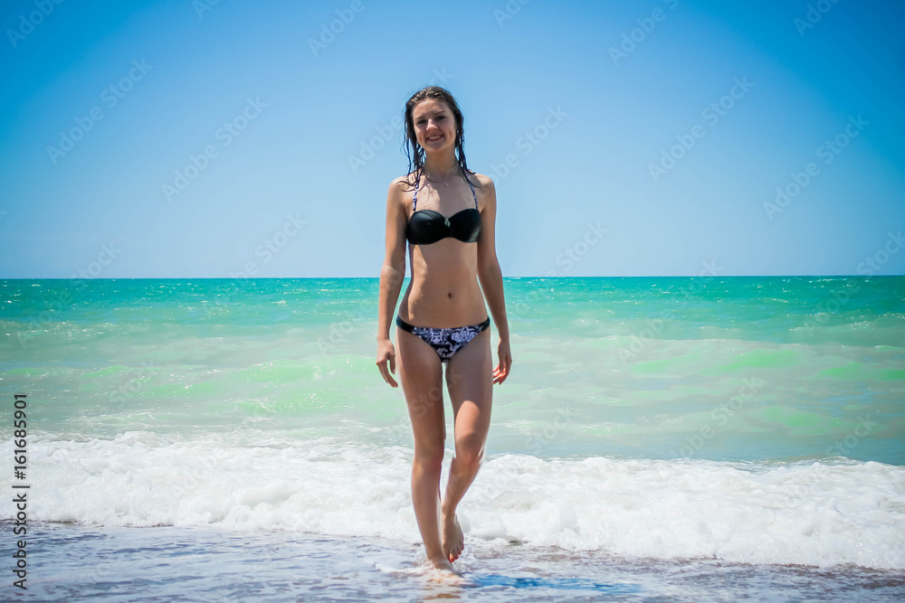 Girl on beach in swimsuit